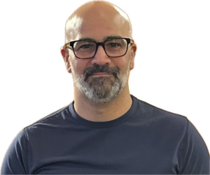 Amgad Bald man with glasses and beard, wearing T-shirt.